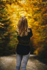 Rear view of woman standing during autumn