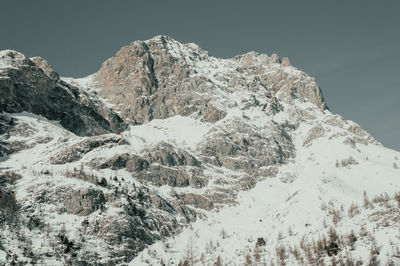 Scenic view of snowcapped mountains against clear sky