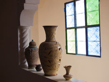 Containers on retaining wall against window