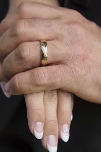 Midsection of couple holding hands