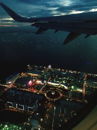 High angle view of illuminated cityscape against sky at night