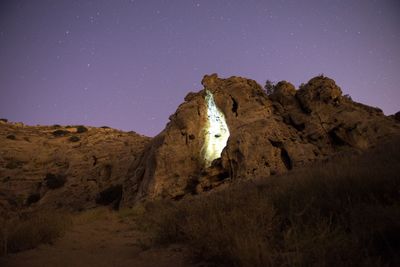 Low angle view of landscape against star field