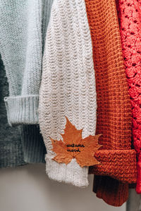 Autumn concept. fall maple leaf with text autumn mood on cozy warm sweater. knitted woolen