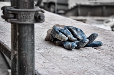 Close-up of statue against wooden railing