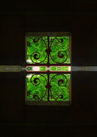 Close-up of metal window on illuminated building