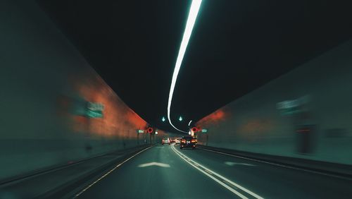 View of illuminated tunnel at night