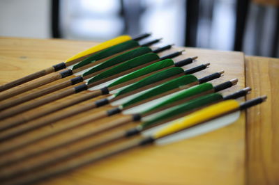 High angle view of multi colored arrows on table