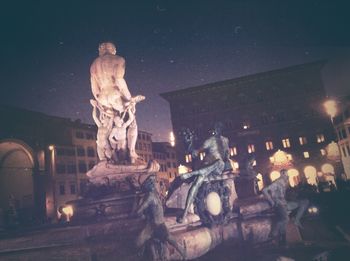 Low angle view of statue at night