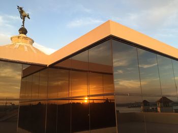 Low angle view of built structure against sunset sky