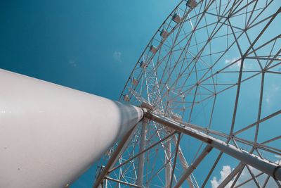 Low angle view of ferris wheel against blue sky