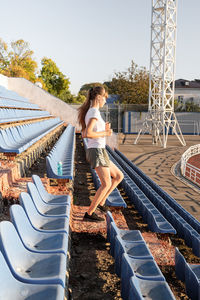 Active lifestyle. teenager girl working out at the staduim running down the stairs