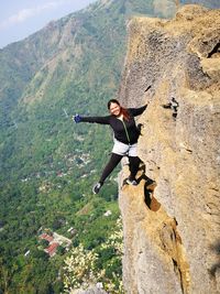 Full length of woman on mountain against sky