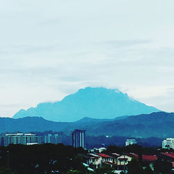 Buildings in town against sky