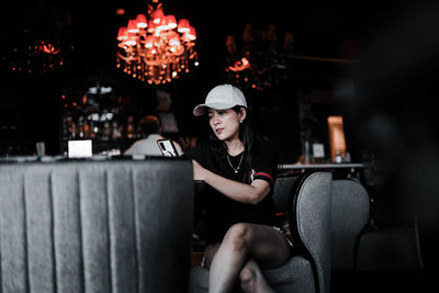 Portrait of young woman using mobile phone while sitting in car