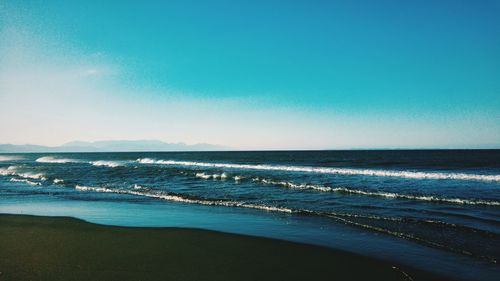 Scenic view of sea against clear blue sky