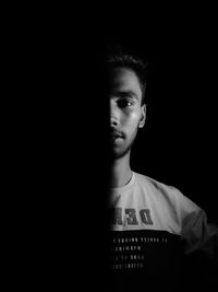 Portrait of man against black background