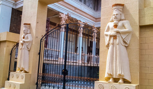 Statue of buddha against building