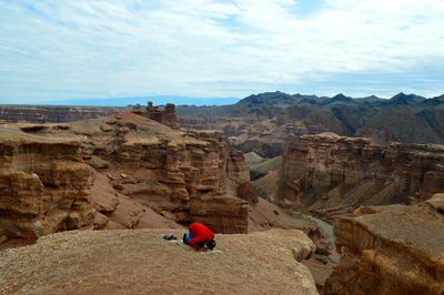 View of man praying in canyon