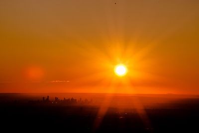 Scenic view of sea against orange sky