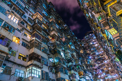 Low angle view of buildings lit up at night