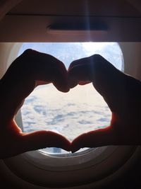 Close-up of heart shape against window