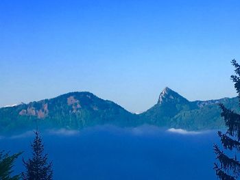 Scenic view of mountains against clear blue sky