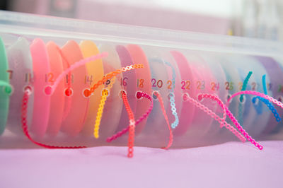 Close-up of multi colored umbrellas on table