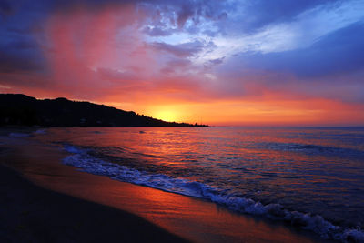 Scenic view of sea against romantic sky at sunset