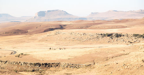 Scenic view of arid landscape against sky