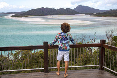 Man at viewpoint looking at the ocean and sandbanks of the withsundays