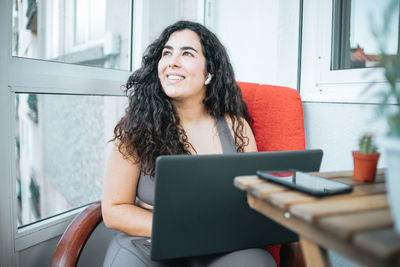 Young woman using laptop at home