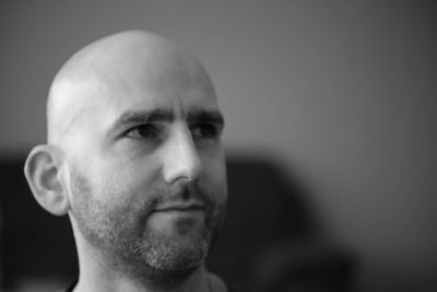 Close-up of man looking away against wall at home