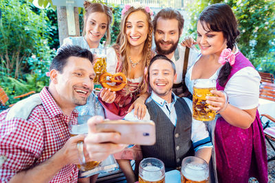 Portrait of smiling friends taking selfie