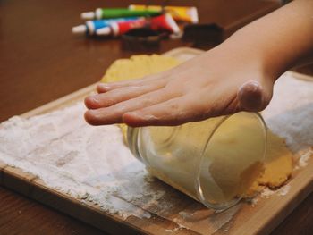 Close-up of person preparing food on cutting board