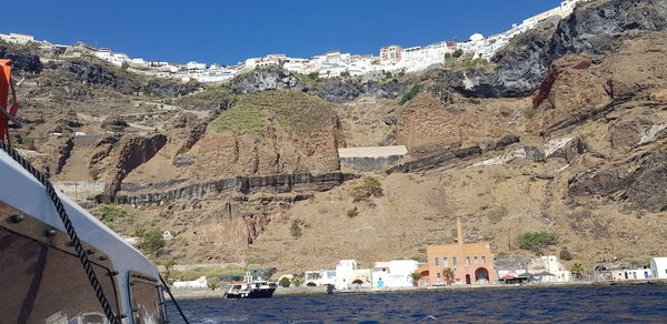 Panoramic view of buildings and mountain against sky