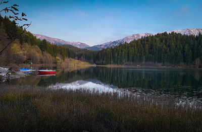 Scenic view of lake and mountains against sky