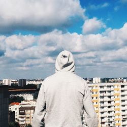 Buildings against cloudy sky