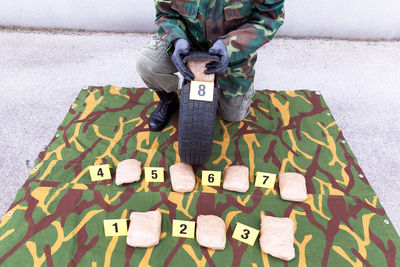 Low section of man putting packages in tire