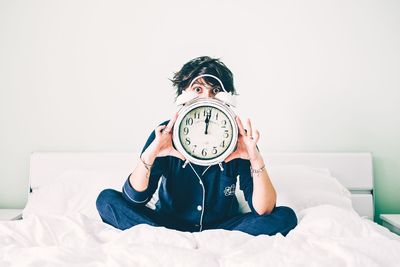 Man sitting on bed at home