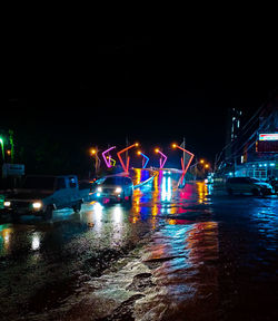 Illuminated city street at night