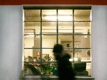 Man seen through window