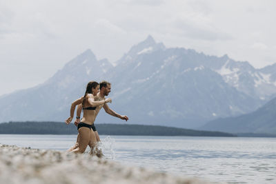 Full length of woman on mountain against sky