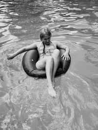 High angle view of woman on inflatable ring in river