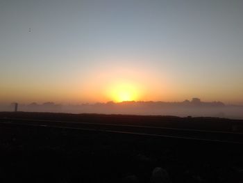 Scenic view of silhouette landscape against clear sky during sunset