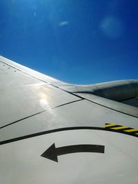Close-up of cropped airplane against clear blue sky