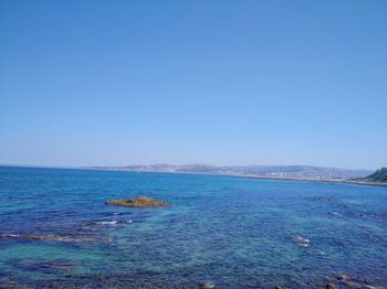 Scenic view of sea against clear blue sky