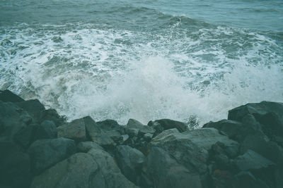 Waves splashing on rocks at shore