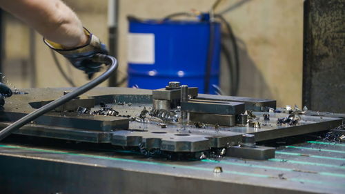 Cropped hand of man working in factory