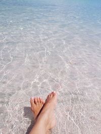 Low section of woman feet in swimming pool