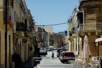 Vehicles on road along buildings